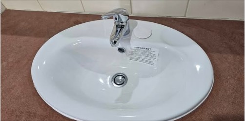 Second white ceramic basin install with chrome mixer on a matching vanity.
